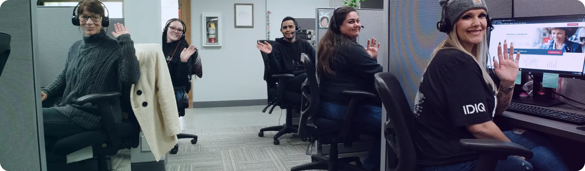 call center employees waving happily