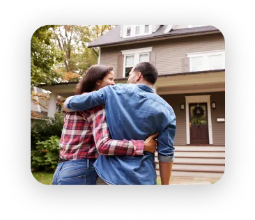 couple standing in front of newly bought house